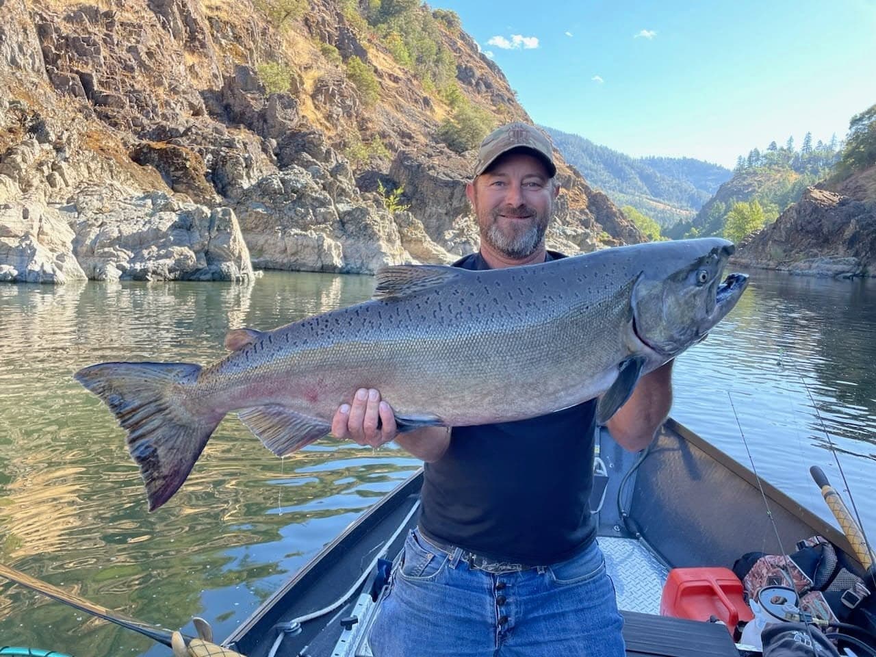 Gabe Lambert holding a trophy Chinook salmon on the Rogue River canyon